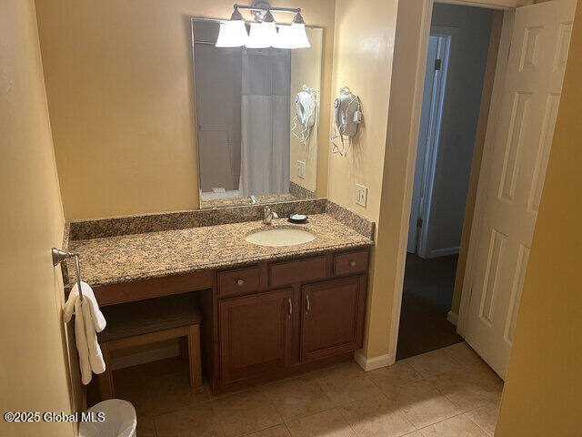 full bath with vanity and tile patterned floors