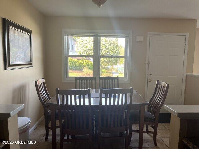 dining space with light tile patterned floors and baseboards