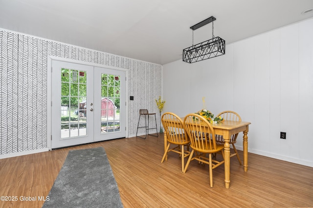 68 Wemple Rd, Bethlehem, NY 12054 - dining space featuring wallpapered walls, french doors, an accent wall, baseboards, and wood finished floors
