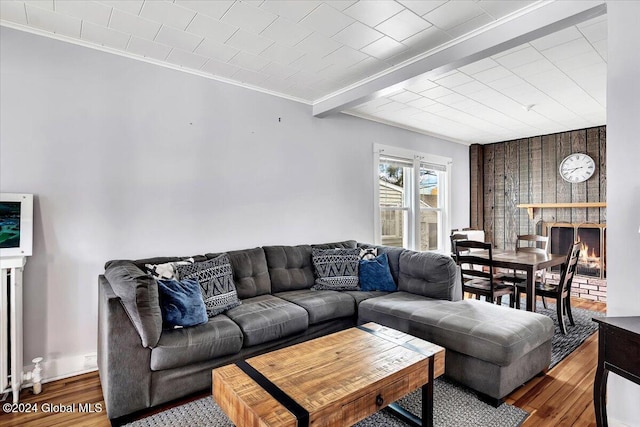 living room with wood finished floors and crown molding