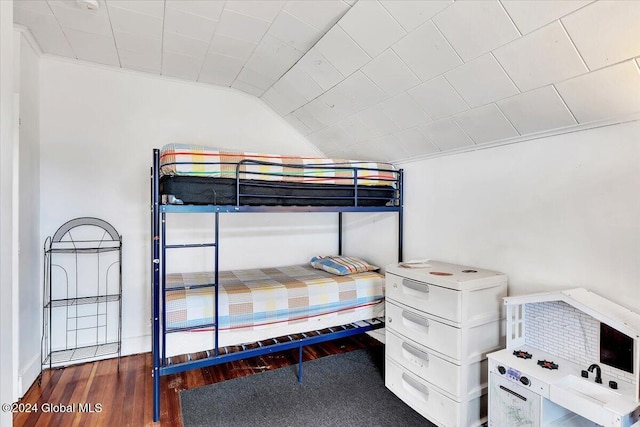 bedroom with lofted ceiling and wood finished floors