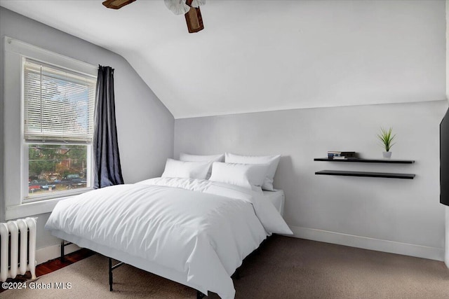 bedroom with baseboards, lofted ceiling, radiator, and a ceiling fan