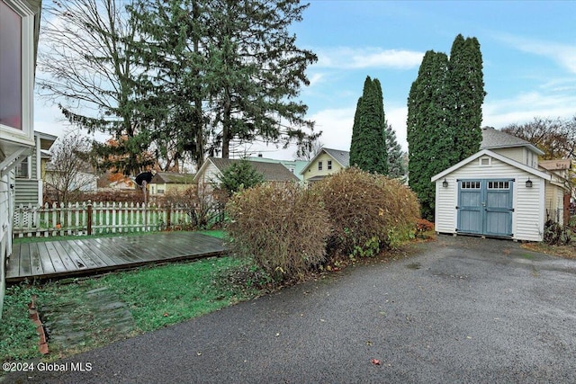 exterior space featuring a storage unit and fence