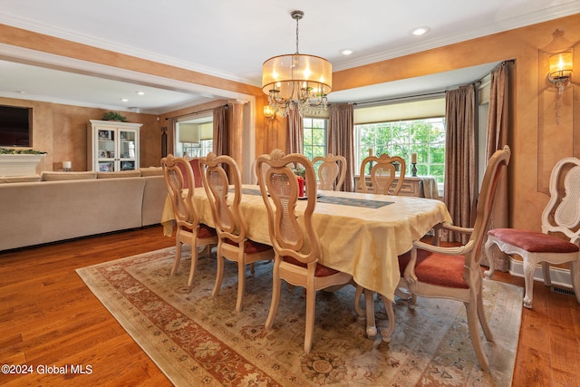 dining room with recessed lighting, crown molding, an inviting chandelier, and wood finished floors