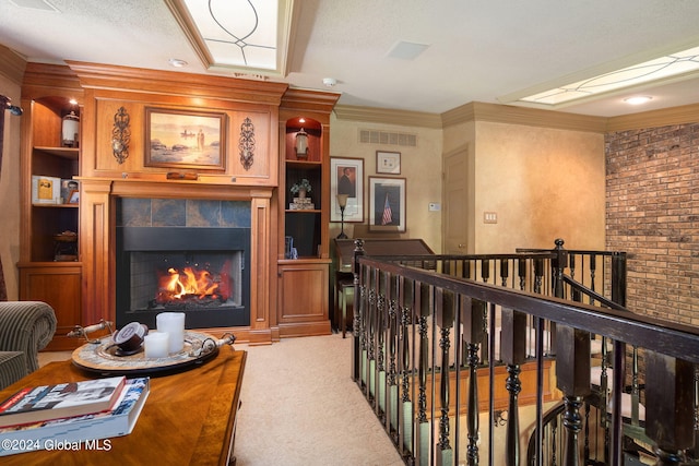 living area with visible vents, light colored carpet, crown molding, and a tiled fireplace