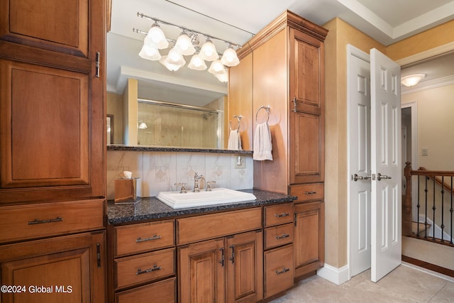 full bath featuring vanity, an inviting chandelier, a shower, and tile patterned flooring