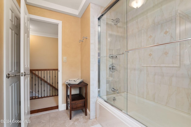 full bath with tile patterned flooring, crown molding, baseboards, and shower / bath combination with glass door