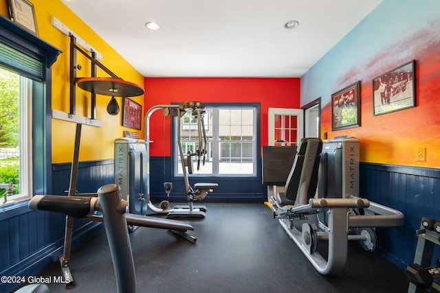 workout area featuring recessed lighting and wainscoting