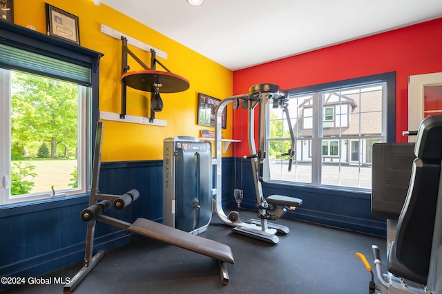 gym featuring a wainscoted wall