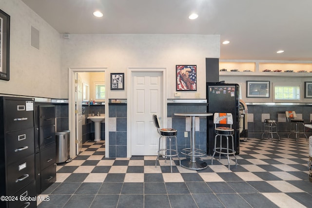 interior space with visible vents, a sink, freestanding refrigerator, recessed lighting, and dark floors