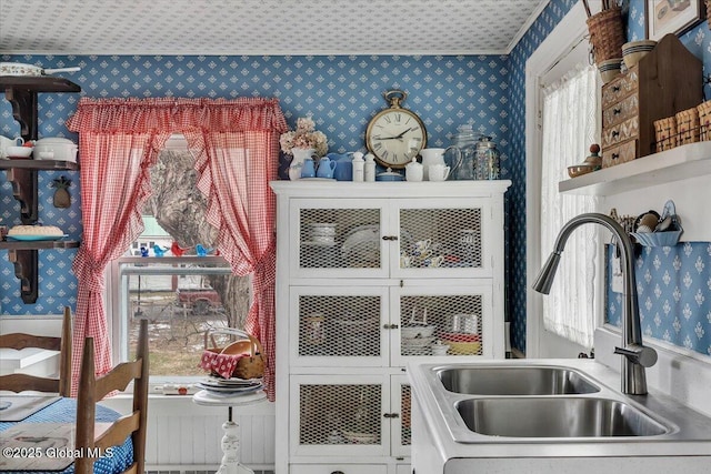 interior details with a sink and wallpapered walls