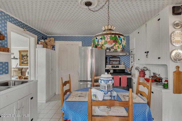 dining area featuring light tile patterned floors and wallpapered walls