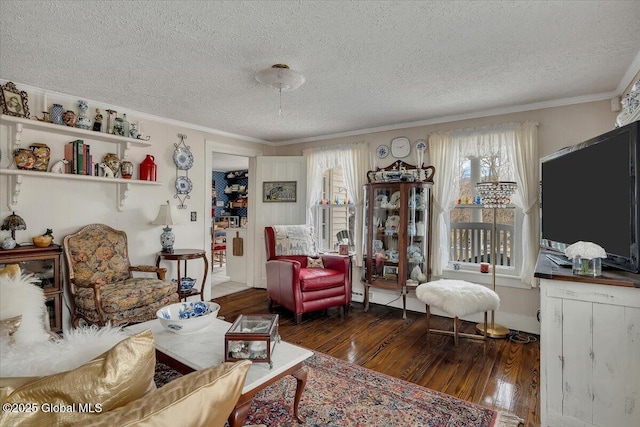 living room featuring crown molding, wood-type flooring, and a textured ceiling