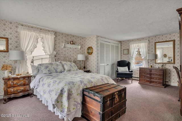 carpeted bedroom with wallpapered walls, a closet, baseboard heating, and a textured ceiling