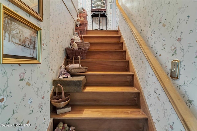 stairway featuring wallpapered walls