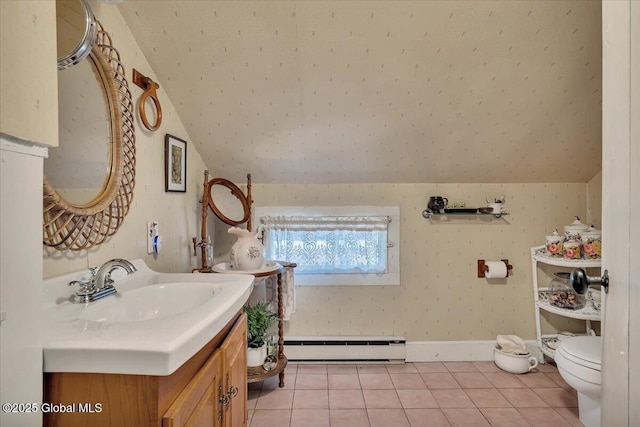 bathroom featuring tile patterned flooring, toilet, vaulted ceiling, vanity, and a baseboard radiator