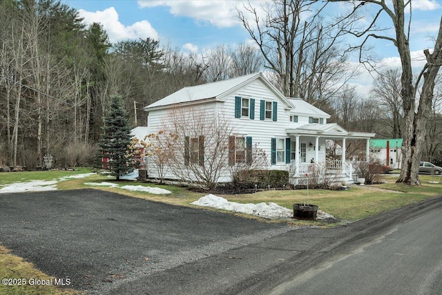 view of front of property featuring covered porch and a front yard