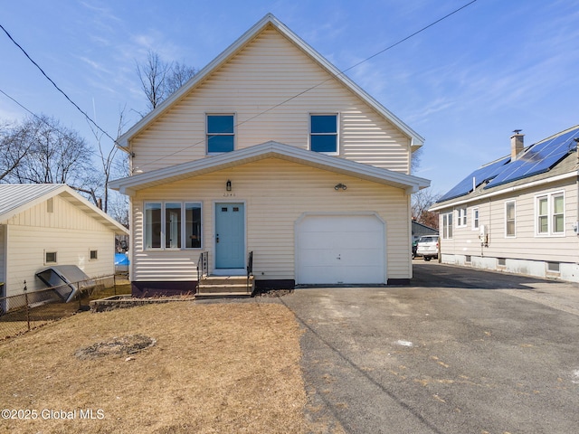 view of front of property featuring driveway, an attached garage, entry steps, and fence