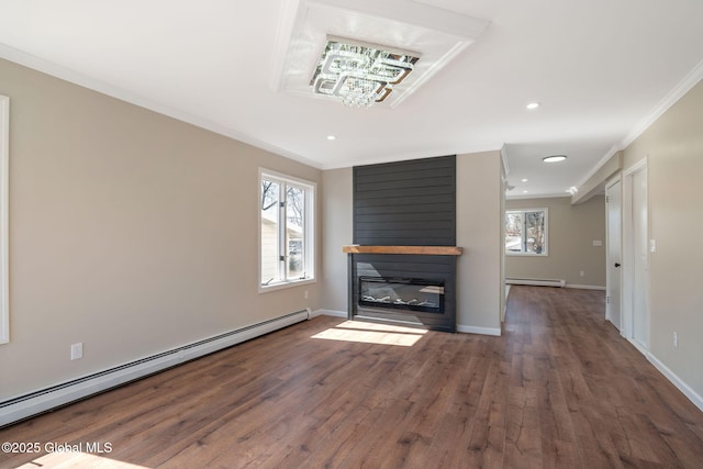 unfurnished living room with a baseboard radiator, a healthy amount of sunlight, and crown molding