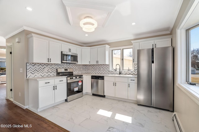 kitchen featuring marble finish floor, white cabinetry, stainless steel appliances, light countertops, and baseboard heating