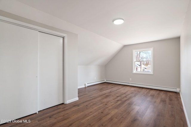 bonus room featuring baseboard heating, wood finished floors, and vaulted ceiling