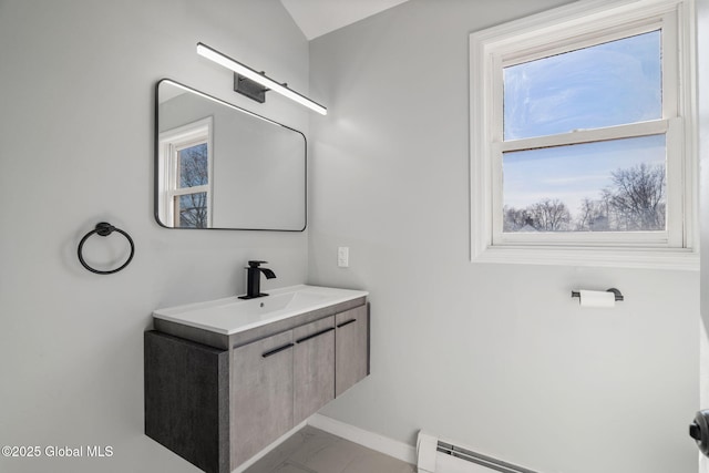 bathroom with vanity, baseboards, and a baseboard radiator