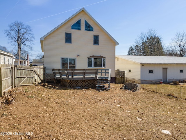 back of property with a gate, a fenced backyard, and a wooden deck