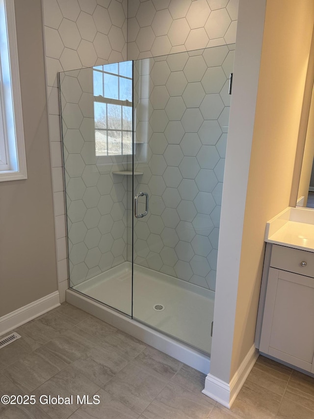 bathroom featuring visible vents, vanity, and a shower stall