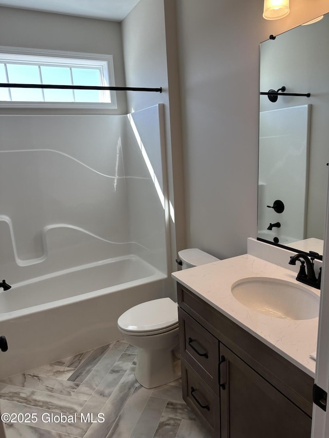 bathroom with toilet, vanity, and bathtub / shower combination