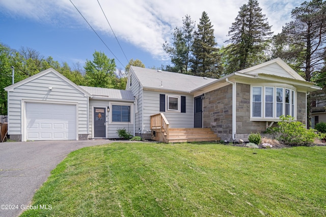 single story home with a garage, stone siding, a front lawn, and aphalt driveway