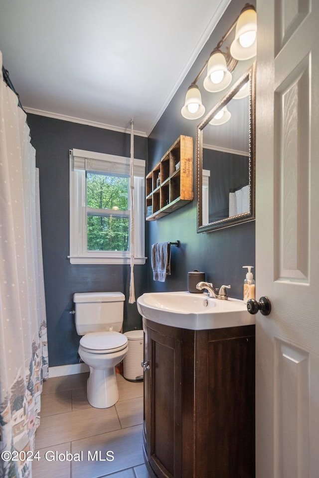 bathroom featuring vanity, baseboards, crown molding, toilet, and tile patterned floors