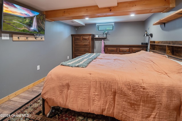 bedroom featuring recessed lighting, baseboards, beam ceiling, and wood finished floors