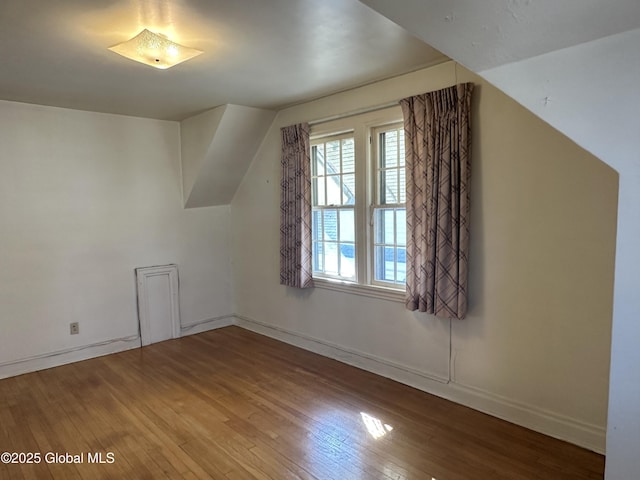 bonus room featuring hardwood / wood-style floors and baseboards