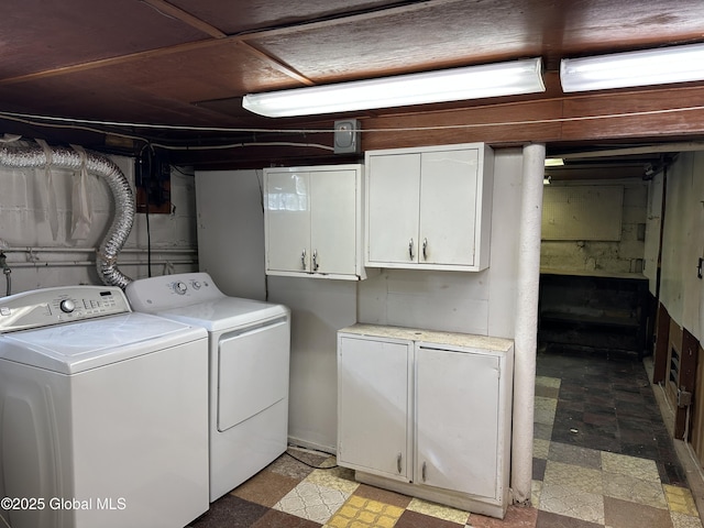 laundry room with cabinet space, separate washer and dryer, and light floors