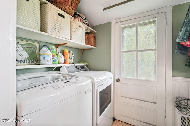 washroom featuring washer and dryer, laundry area, a wainscoted wall, and a wealth of natural light