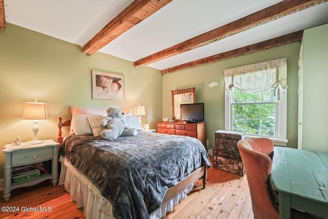 bedroom featuring beam ceiling and hardwood / wood-style floors