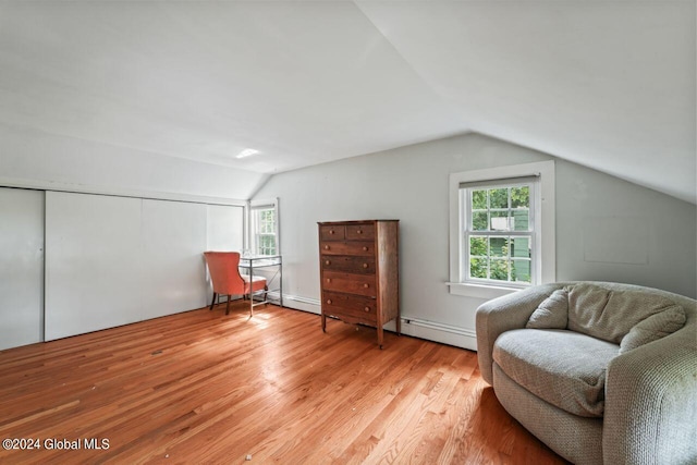 sitting room featuring lofted ceiling and light wood-style floors