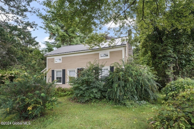 view of property exterior with metal roof