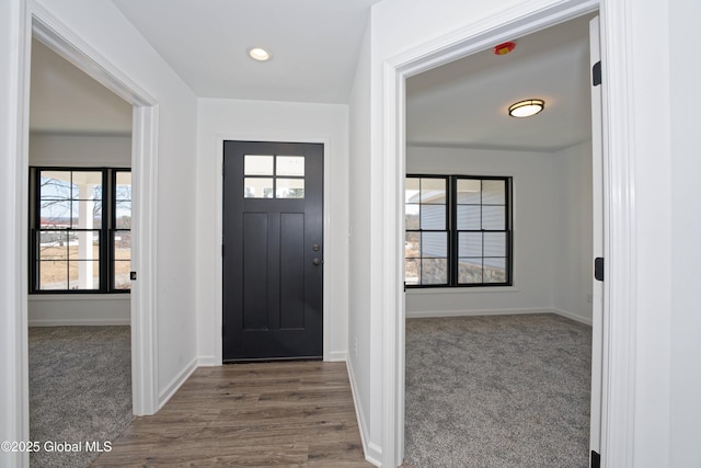 entrance foyer with recessed lighting, carpet, baseboards, and a healthy amount of sunlight