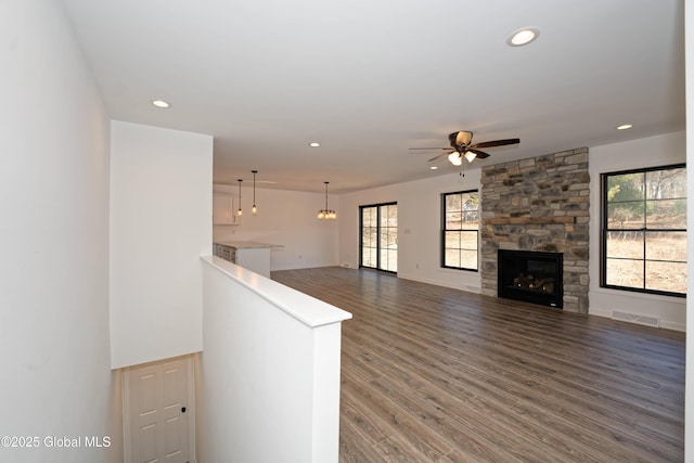 unfurnished living room featuring a ceiling fan, recessed lighting, wood finished floors, and visible vents