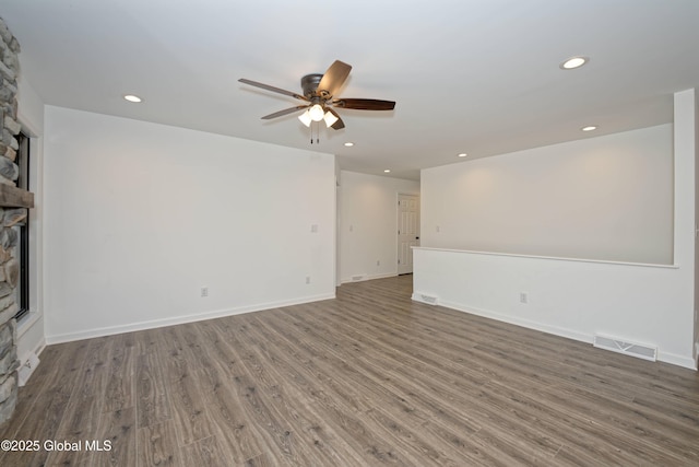 unfurnished living room featuring visible vents, recessed lighting, a fireplace, wood finished floors, and a ceiling fan