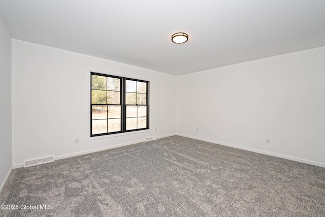 carpeted empty room with visible vents and baseboards