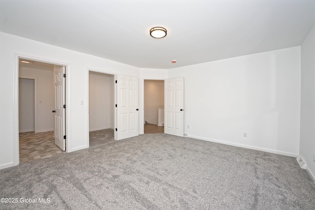 unfurnished bedroom featuring baseboards and carpet floors