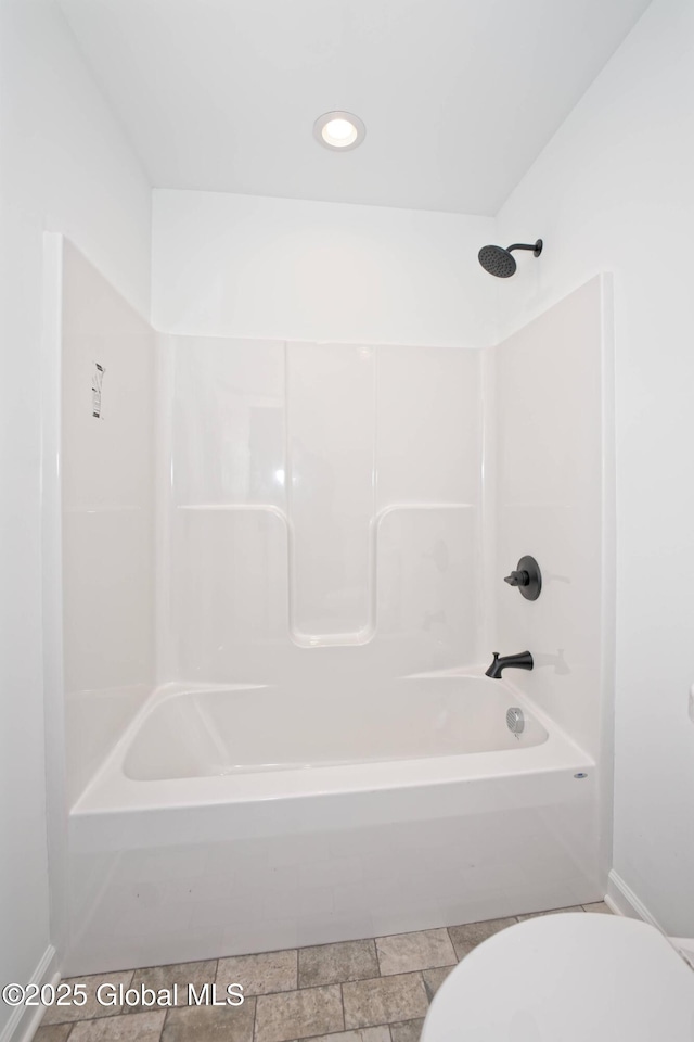 full bath with baseboards, toilet, and  shower combination