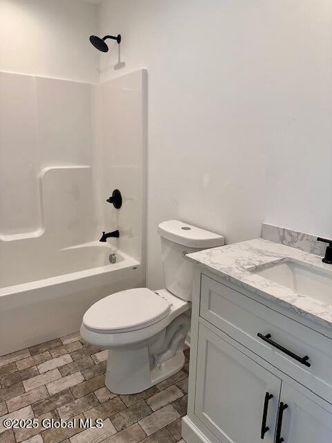 full bath with toilet, vanity, and washtub / shower combination