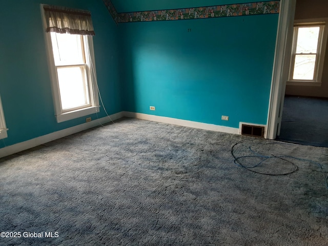 unfurnished room with baseboards, visible vents, and carpet floors