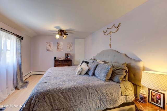 bedroom featuring light wood-style flooring, a ceiling fan, and vaulted ceiling