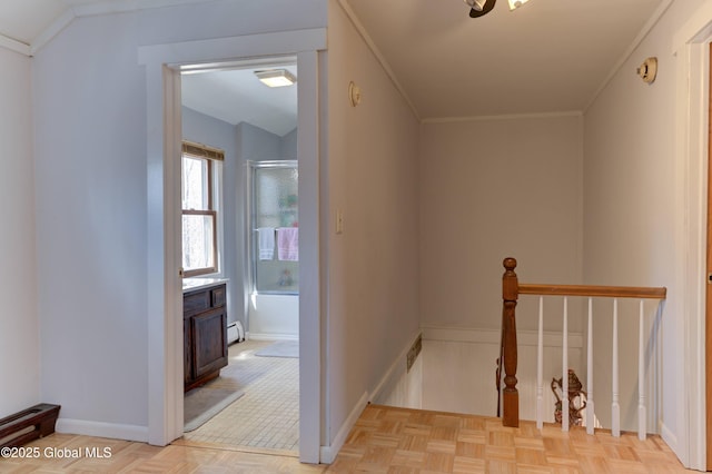 corridor featuring visible vents, baseboards, a baseboard radiator, ornamental molding, and an upstairs landing