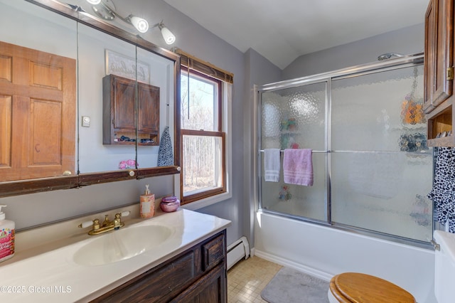 bathroom with a baseboard heating unit, shower / bath combination with glass door, vanity, and vaulted ceiling