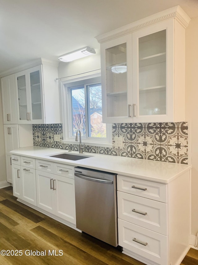 kitchen with white cabinets, dishwasher, light countertops, and a sink